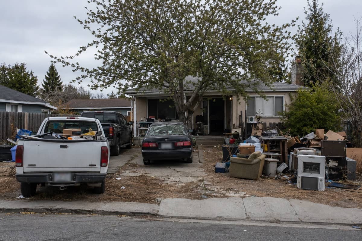 A rental home left damaged and littered with debris by tenants.