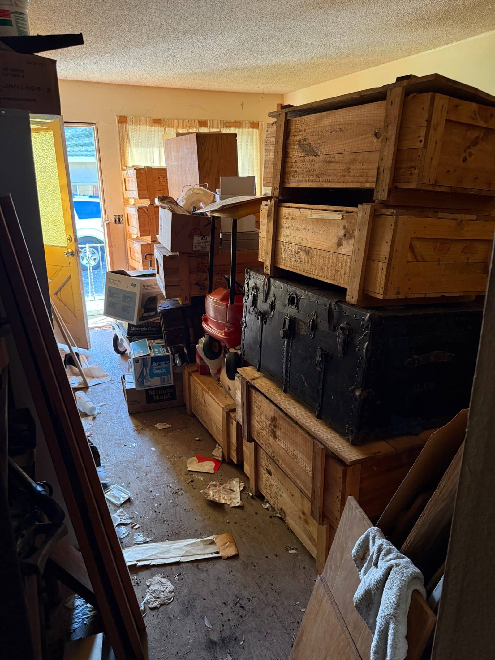 A room left full of crates, an old trunk, and a lifetime of belongings when we bought the home.